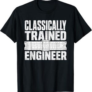 May include: A black short-sleeve t-shirt featuring white distressed text that reads "CLASSICALLY TRAINED ENGINEER" with a graphic of a slide rule positioned between the words "TRAINED" and "ENGINEER" on the front of the garment.