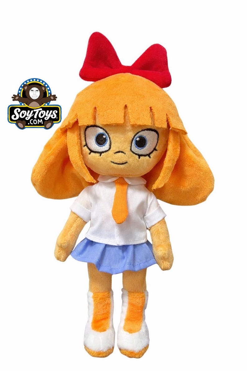 May include: A plush doll with orange hair, a red bow, and blue eyes. The doll wears a white shirt, blue skirt, orange tie, and white shoes with orange accents. The doll is a product of SoyToys.com.