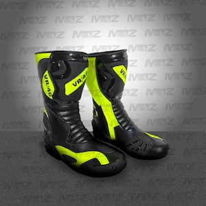 May include: Pair of black and neon yellow motorcycle boots. The boots have a high-top design with the text "VR/46" on the side. The boots are made of leather and have a rubber sole. The boots are designed for protection and style.