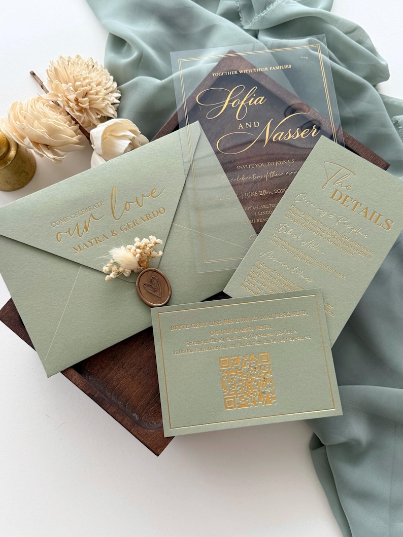 May include: Sage green wedding invitation suite with gold foil lettering. Includes an invitation, details card, RSVP card, and envelope. The invitation features the names "Sofia and Nasser". The envelope is sealed with a wax stamp.