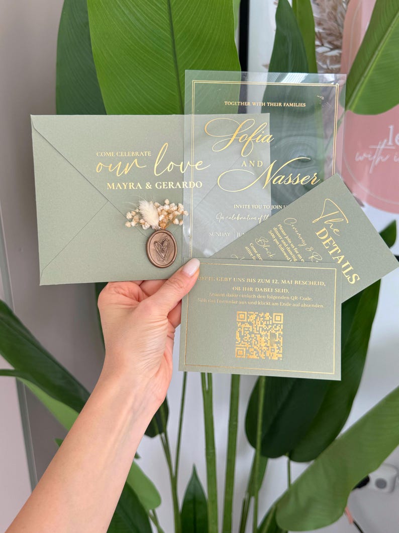 May include: Sage green wedding invitation suite with gold foil lettering. The invitation includes an envelope, a clear acrylic card, and a details card. The envelope is sealed with a wax stamp and dried flowers. The text reads "Come Celebrate our love Mayra & Gerardo".