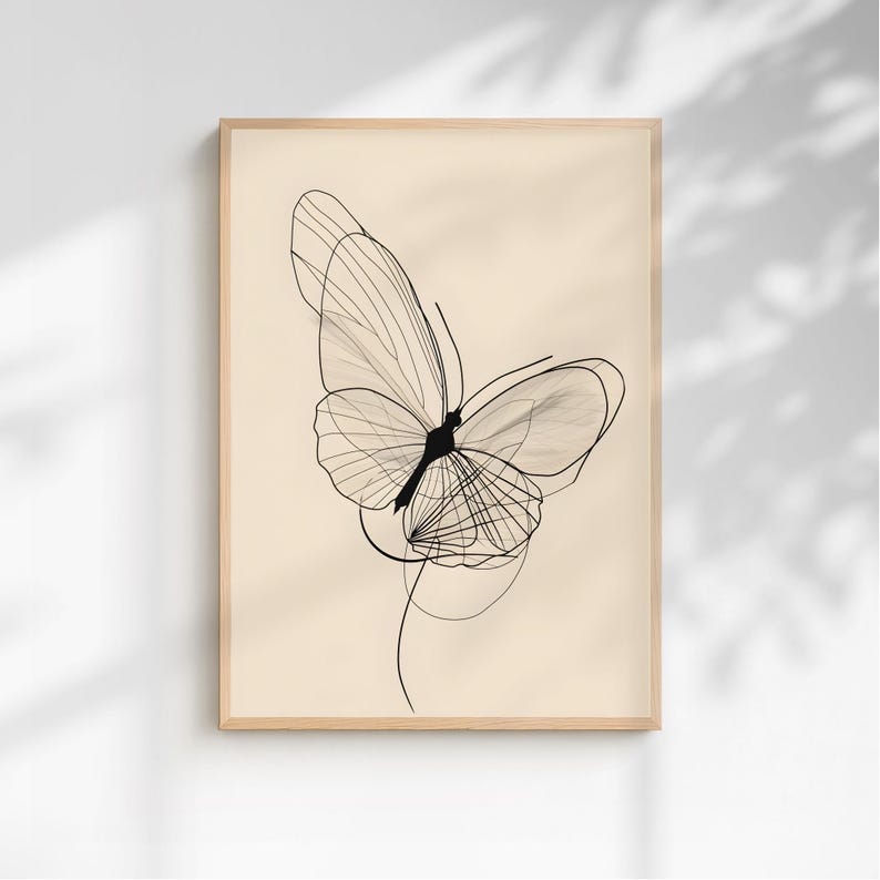 May include: A framed wall art print featuring a black line drawing of a butterfly on a solid light beige background. The butterfly illustration is composed of thin, overlapping lines that create a delicate, layered wing structure and body.
