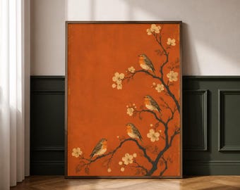 May include: A rectangular wall art print featuring a deep orange background with a dark brown tree branch extending from the right side. Four small birds with orange breasts and grey wings are perched on the branches among white cherry blossoms.