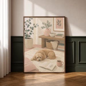 May include: A framed print shows a relaxed interior. A light brown dog lies on a rug, beside an open book and a pink mug. A small wooden table holds a vase, bowl, and books. The artwork has a warm, inviting aesthetic.