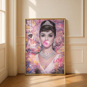 May include: A framed art print featuring a portrait of a woman with a pink bubble gum bubble. She wears a tiara, diamond earrings, and a diamond necklace. The background is a colorful abstract design with the word "Art" and "Love".