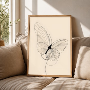 May include: A framed wall art print featuring a black line drawing of a butterfly on a cream-colored background. The butterfly illustration is composed of thin, overlapping lines that create a delicate, layered wing structure within a wooden frame.