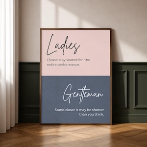Può includere: Un cartello rettangolare con cornice marrone scuro, diviso orizzontalmente in una metà superiore rosa chiaro e una metà inferiore blu scuro. La sezione superiore riporta Ladies Please stay seated for the entire performance. La parte inferiore riporta Gentleman Stand closer it may be shorter than you think.