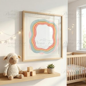 May include: A framed watercolor print with a rainbow design in pastel colors. The artwork is displayed on a white wall, alongside a shelf with a crochet lamb, wooden blocks, and a potted succulent. A crib is visible in the background.