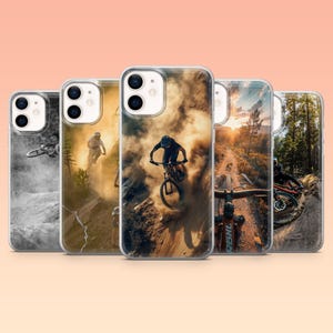 May include: Five phone cases showcasing mountain biking scenes. The cases depict cyclists on dirt tracks, creating dust clouds, and executing jumps. The cases have a clear, glossy finish, offering protection and a vibrant display.