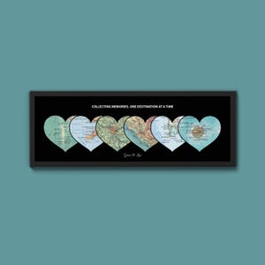 May include: A framed artwork featuring six heart-shaped map cutouts against a black background. The maps are in shades of green, blue, and brown. The text "COLLECTING MEMORIES, ONE DESTINATION AT A TIME" is above the hearts. The artist's name is at the bottom.
