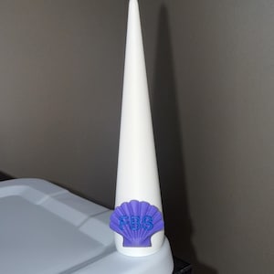 May include: A tall, white, conical-shaped object featuring a purple seashell emblem attached to the base. The seashell has the letters FBS embossed in blue on its surface. The object has a smooth, matte finish and a pointed top.