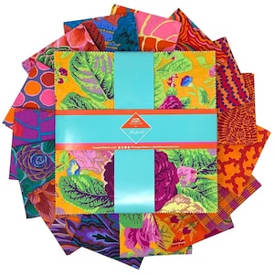 May include: A collection of colorful fabric squares with floral and abstract patterns. The squares are arranged around a central package wrapped in turquoise ribbon. The fabric features shades of orange, pink, purple, and green. The package has text that reads "Kaffe Fassett Collective".