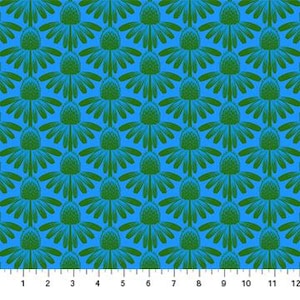 May include: A repeating pattern of green stylized flower shapes on a bright blue background. The flowers have a central cone shape with radiating petals. A ruler is at the bottom of the image, showing inches.
