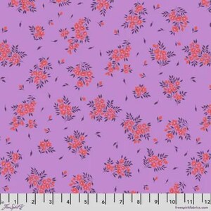 May include: A floral fabric with a lavender background. The pattern features clusters of coral-colored flowers with dark purple leaves and small, scattered leaf shapes. The fabric has a repeating design, with a ruler at the bottom showing inches.