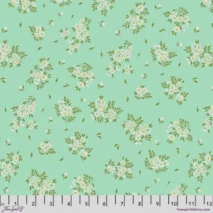May include: A fabric with a repeating pattern of white floral clusters and small green leaves on a light green background. The floral design is scattered across the fabric, creating a delicate and airy feel. The fabric is measured in inches.