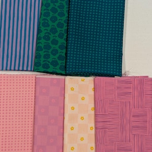 May include: A collection of seven fabric swatches featuring various patterns and colors. The top row includes blue and purple stripes, green floral prints, and dark teal polka dots. The bottom row displays pink dots, pink checkered flowers, light orange checkered flowers, and pink textured lines.
