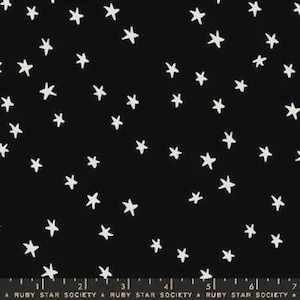 May include: Black fabric with a white star pattern. The stars are hand-drawn in various sizes and orientations. The fabric is likely cotton or a similar material, suitable for quilting or apparel.