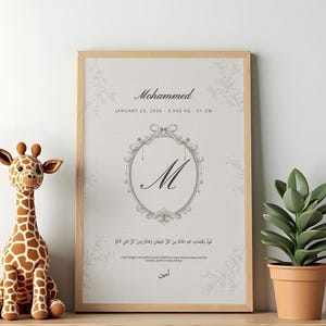 Peut inclure: Un cadre avec le nom "Mohammed" et les détails de naissance : 23 janvier 2026, 3,560 kg, 51 cm. L'impression présente un motif ovale orné avec la lettre "M" et des caractères arabes. Une girafe en peluche et une plante en pot sont sur l'étagère.