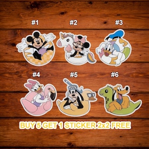 May include: A collection of six colorful stickers featuring Disney characters in summer-themed designs. Mickey Mouse, Minnie Mouse, Donald Duck, Daisy Duck, Goofy, and Pluto are depicted on floats and in swim gear. The text "BUY 5 GET 1 STICKER 2x2 FREE" is also visible.