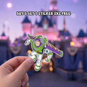 May include: A die-cut sticker featuring the character Buzz Lightyear in a white, green, and purple space suit with extended wings. The text above reads BUY 5 GET 1 STICKER 2X2 FREE. The sticker is held against a blurred background of a castle.