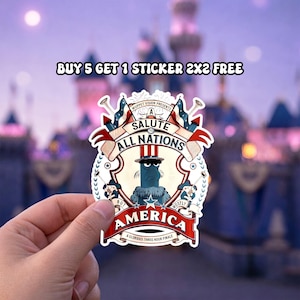 May include: A sticker featuring a cartoon character with a blue face and a hat, surrounded by flags and the text "SALUTE TO ALL NATIONS" and "AMERICA". The sticker also includes the text "BUY 5 GET 1 STICKER 2X2 FREE".