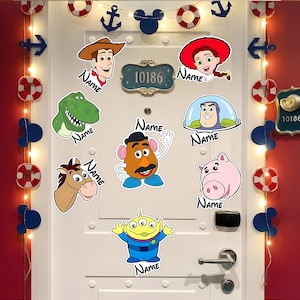 May include: A white door decorated with various Toy Story character stickers, including Woody, Jessie, Rex, Buzz Lightyear, Mr. Potato Head, and others. The door also features nautical-themed decorations like anchors and life preservers, along with a string of lights.