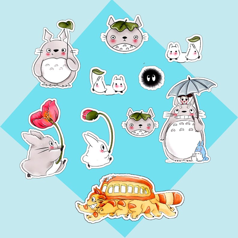 May include: A collection of die-cut stickers featuring various animated characters, including a large grey creature holding a leaf, a cat-shaped bus, small white spirits, a black soot sprite, and a grey creature holding a grey umbrella.