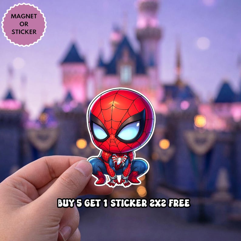 May include: A die-cut sticker or magnet featuring a stylized, chibi-style Spider-Man character in a crouching pose with a red and blue suit, large white eyes, and a black web pattern. Text on the image reads: MAGNET OR STICKER and BUY 5 GET 1 STICKER 2X2 FREE.