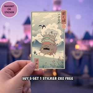May include: A rectangular magnet or sticker featuring a stylized illustration of a mechanical castle on legs walking through a grassy landscape. The artwork includes Japanese text, a bird in the sky, and a mountain backdrop in muted tones of green, tan, and brown.