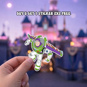 May include: A die-cut sticker featuring the character Buzz Lightyear in a white, green, and purple space suit with extended wings. The text above reads BUY 5 GET 1 STICKER 2X2 FREE. The sticker is held against a blurred background of a castle.