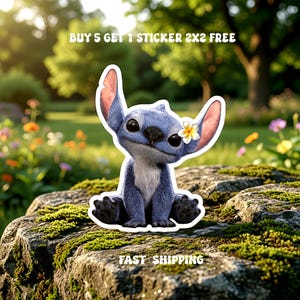 May include: A blue cartoon character sticker with large ears and a flower behind one ear. The sticker is on a mossy rock with the text "BUY 5 GET 1 STICKER 2X2 FREE" and "FAST SHIPPING".