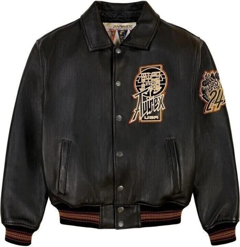 May include: Black leather jacket with a button-up front, featuring a collar and ribbed cuffs. The jacket has embroidered patches with text and a logo, and a brown and gold striped hem. The jacket has two front pockets.