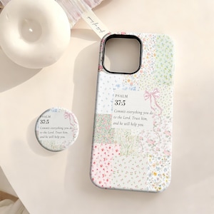 May include: Floral patchwork phone case and matching pop socket. The case and pop socket feature a mix of pastel floral patterns and the text "PSALM 37:5: Commit everything you do to the Lord. Trust him, and he will help you."