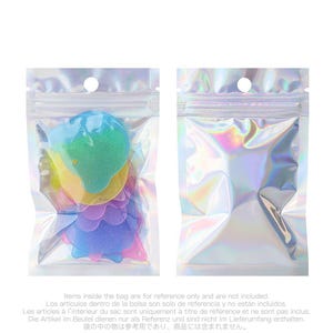 May include: Two clear, iridescent zip-lock bags. One bag contains colorful, heart-shaped items with glitter. The other bag is empty. The bags have a small hole at the top. Text at the bottom states items inside the bag are for reference only.