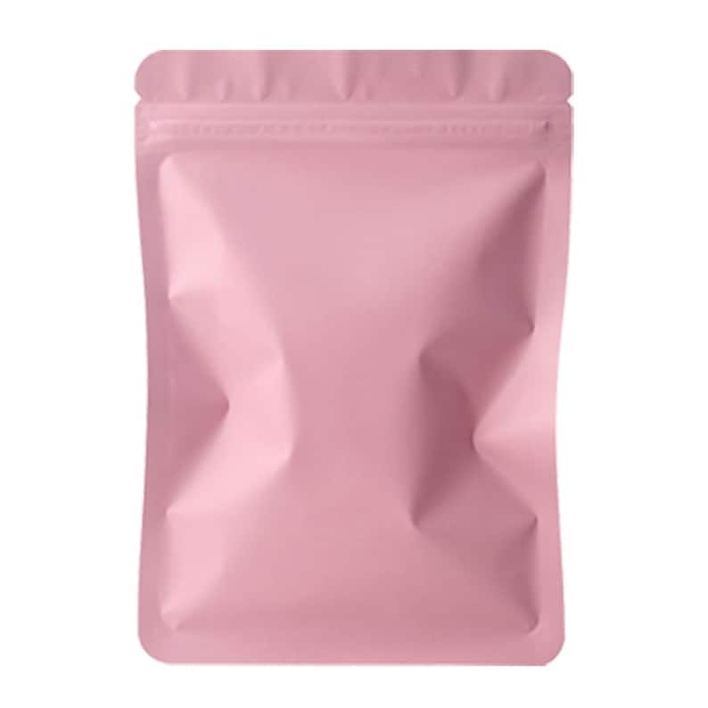May include: A pink, rectangular, resealable pouch with a zip closure at the top. The pouch has a matte finish and is empty. The sides of the pouch are creased, giving it a three-dimensional appearance. The overall shape is a simple, clean design.