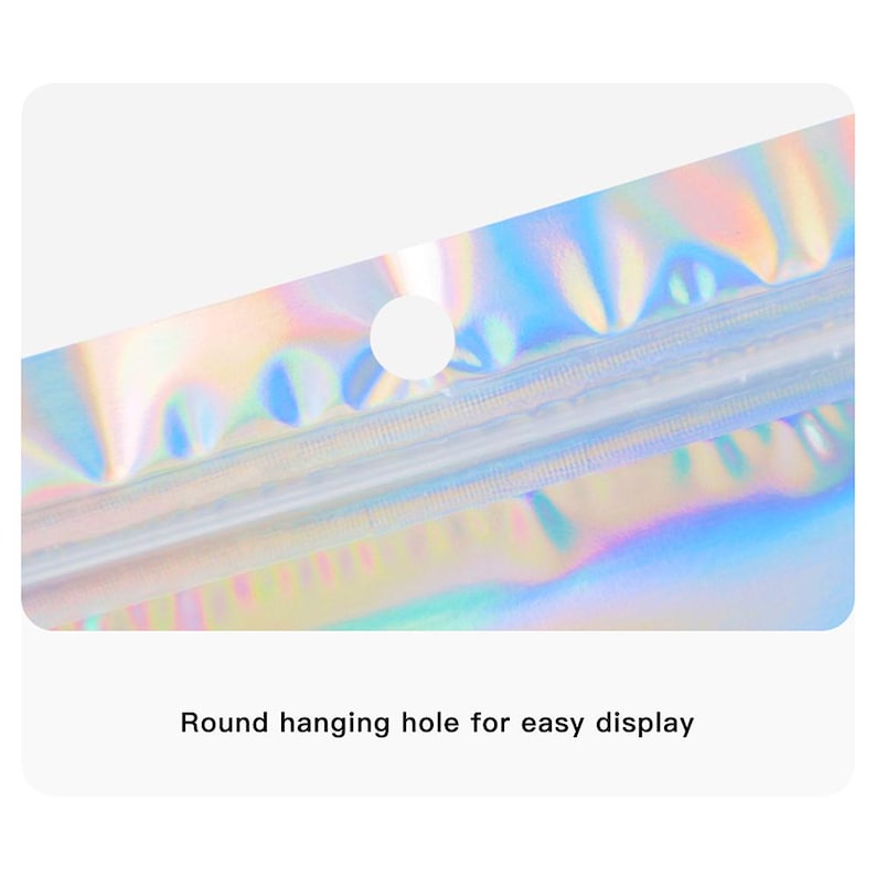 May include: Close-up of a holographic, iridescent bag with a round hanging hole for easy display. The bag reflects a spectrum of colors, including blues, greens, and pinks. The text "Round hanging hole for easy display" is visible.