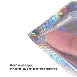 May include: Close-up of a clear, iridescent pouch with reinforced edges. The pouch is partially open, with a finger visible inside. Text at the bottom reads "Reinforced edges for durability and puncture resistance."