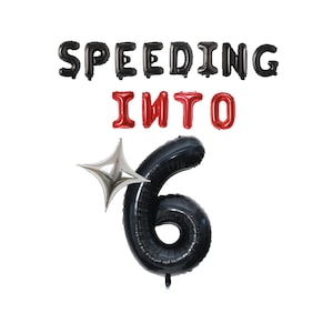 May include: Black and red foil balloons spelling "SPEEDING INTO 6" with a silver star-shaped balloon. The number 6 is a large black balloon. Party decorations for a birthday or celebration.