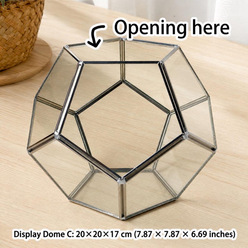 May include: A clear glass geometric terrarium with a metallic frame, shaped as a dodecahedron. The object features an open top section labeled with the text Opening here. It measures 7.87 x 7.87 x 6.69 inches, identified as Display Dome C.