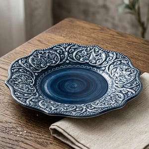 May include: A handmade wooden serving tray with a natural finish. The rectangular tray has rounded corners and two carved handles. The visible wood grain adds to its rustic charm. Ideal for serving food or displaying items.