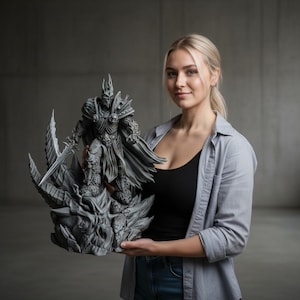 May include: A gray statue of a fantasy character, holding a sword, with intricate armor and a cape. The statue is mounted on a detailed base. The figure is a detailed representation of a character from a popular video game.