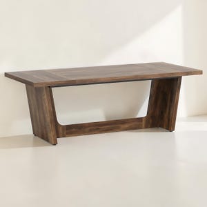 May include: A dark brown wooden table with a rectangular top and angled legs. The table has a modern design and is made of solid wood. The table is approximately 72 inches long, 36 inches wide, and 30 inches high.