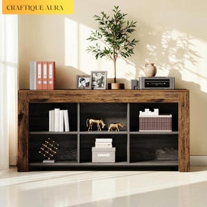 May include: A rustic wooden bookshelf with multiple compartments. The top shelf displays decorative items like a small tree, picture frames, and a stereo system. The lower shelves hold books, boxes, and decorative animal figurines. The text "CRAFTIQUE AURA" is in the top left corner.