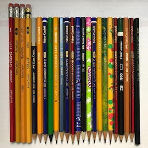 May include: A white ceramic mug with a black handle and the text "But First, Coffee" in a handwritten style. The mug is on a white surface. The mug is approximately 4 inches tall.