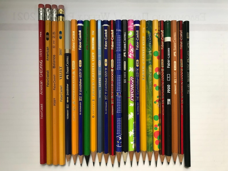 May include: A white ceramic mug with a black handle and the text "But First, Coffee" in a handwritten style. The mug is on a white surface. The mug is approximately 4 inches tall.