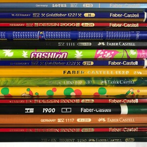 May include: A white ceramic mug with a black handle and the text "But First, Coffee" in a black, bold font. The mug is sitting on a wooden surface. The mug is approximately 4 inches tall.