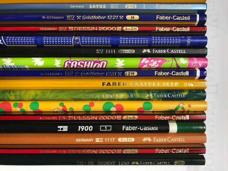 May include: A white ceramic mug with a black handle and the text "But First, Coffee" in a black, bold font. The mug is sitting on a wooden surface. The mug is approximately 4 inches tall.