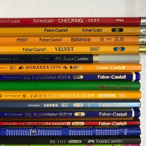 May include: A white ceramic mug with a black handle and the text "But First, Coffee" in a bold, black font. The mug is set against a blurred background, suggesting a cozy setting. The mug appears to be approximately 4 inches tall.