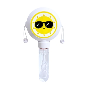 May include: A white plastic bubble wand featuring a circular top with a yellow sun graphic wearing black sunglasses. The handle is a clear cylindrical container filled with bubble solution, and two white strings with small beads hang from the sides.
