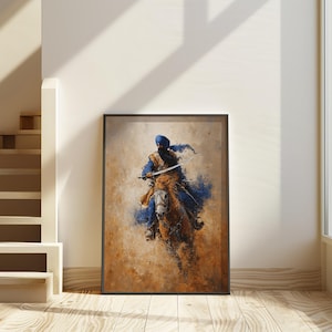 May include: Framed art print of a Sikh warrior on horseback, painted in a loose, expressive style. The artwork shows a figure in blue and gold, holding a sword, against a background of browns and tans. The image is framed in a black border.